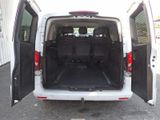a white van with its doors open in a parking lot