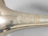 a silver trumpet that is sitting on a table