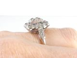 an image of a woman ' s hand holding a diamond ring