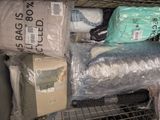 many bags of clothing in the back of a truck
