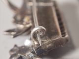 a close up of a silver object on a table