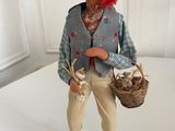 a figurine of a man holding a basket of food