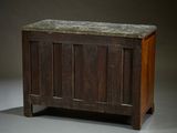 a wooden chest with a marble top on a gray surface