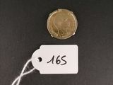 a close up of a coin with a tag attached to it