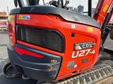 a close up of the front end of a red tractor