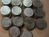 a pile of silver coins sitting on a wooden table