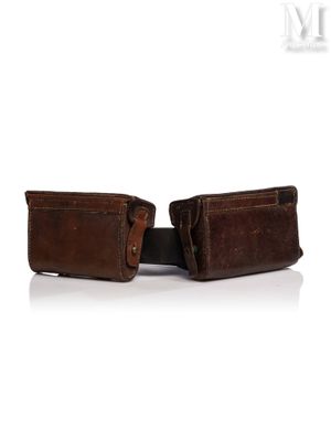 two brown leather wallets sitting next to each other on a white surface