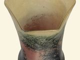 a vase that is sitting on a white surface