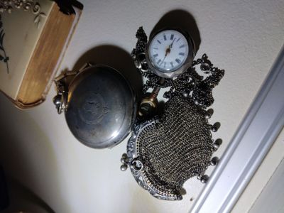 a clock that is on the wall next to a purse