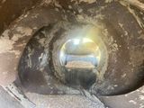 a dirty toilet with a hole in the middle of it
