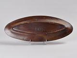 an image of a wooden plate with a metal stand on a white surface