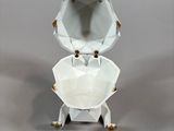 porcelain figurine of an elephant holding a bowl on a stand