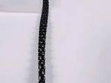 a black chain that is laying on top of a table