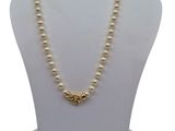 a close up of a mannequin with a necklace on it