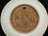 a white plate with a brown and black design on it