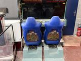 two arcade machines sitting next to each other in a room