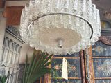 a glass chandelier hanging from a ceiling in a room