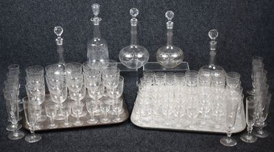 bottles and glasses are lined up on a tray on a table