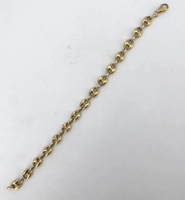 a close up of a gold chain on a white surface