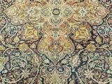 a close up of a large oriental rug on a wooden floor