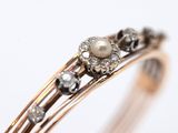 an image of a close up of a ring with pearls and diamonds