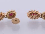 a pair of gold and ruby earrings