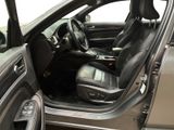 the interior of a car with the door open and the driver ' s seat down