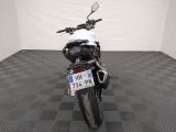 a motorcycle that is parked in a room with a checkered floor