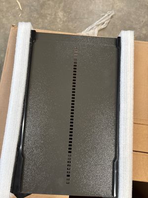 an open laptop computer sitting on top of a cardboard box