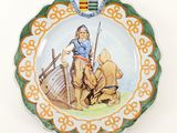 a plate with a picture of a man on a boat on it