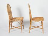pair of wicker chairs with wooden seat and backrests against a white background