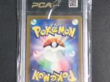 a close up of a pokemon card in a plastic case