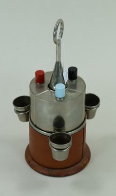une cafetière argentée et marron posée sur un socle en bois