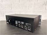 a close up of a black amplifier sitting on a table