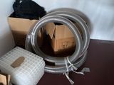 a pile of boxes and a hose in a room