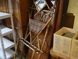 a pile of old furniture in a room next to a bookshelf