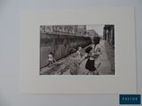 a black and white photo of a group of children on the street