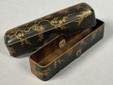 two black and gold boxes sitting on top of a white surface