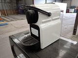 a coffee machine sitting on top of a table in a warehouse
