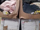 two boxes of clothes on top of each other in a warehouse