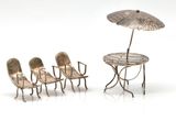 four chairs and a table with an umbrella on it