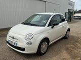a small white car parked in front of a building