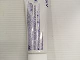 a tube of toothpaste sitting on a counter