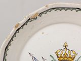 a plate with a crown on it and a bird on the plate