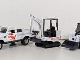 several toy trucks are lined up in a row on a white surface