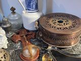 a lot of antique items on a table with a blue and white vase
