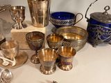 a table with a lot of silver and silverware on it