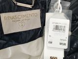 the label is attached to a black jacket with a gold chain