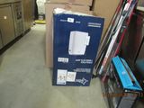 a box that is sitting on the floor next to a refrigerator