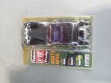 a toy car that is in a package on a table